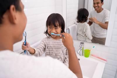 family dentist arvada | family brushing teeth