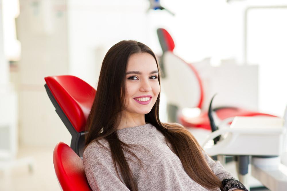 woman smiling after getting teeth cleaned at Five Parks Dental