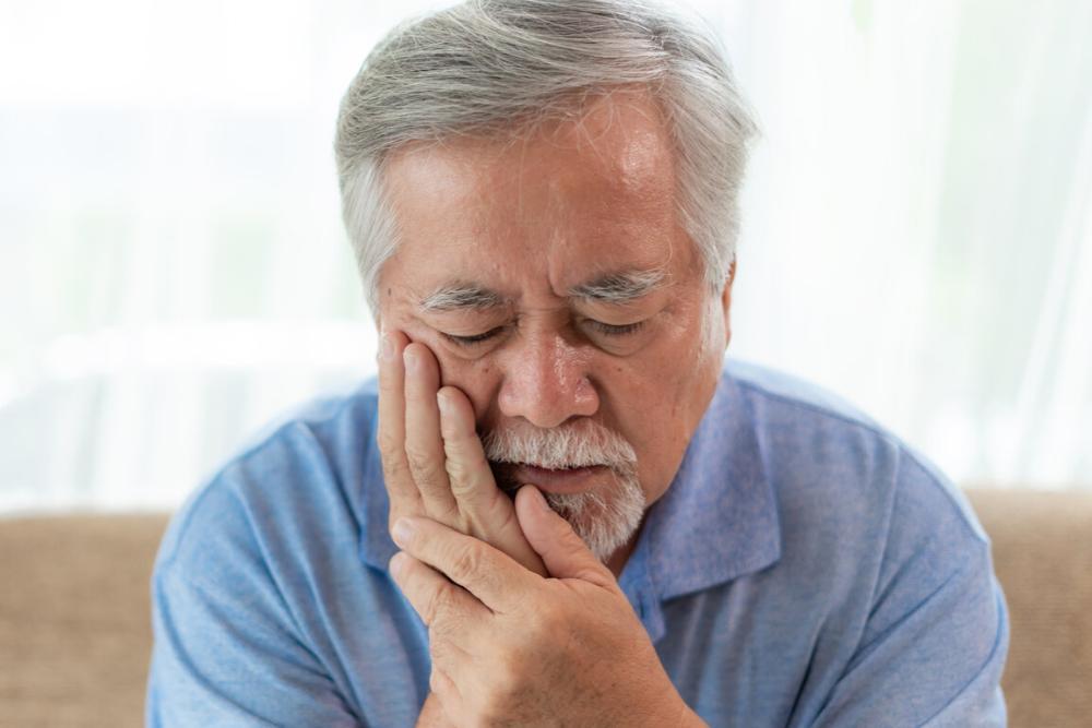 man holding just jaw from teeth grinding pain
