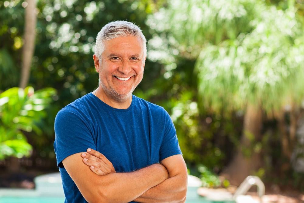 man smiling after getting a missing tooth replaced