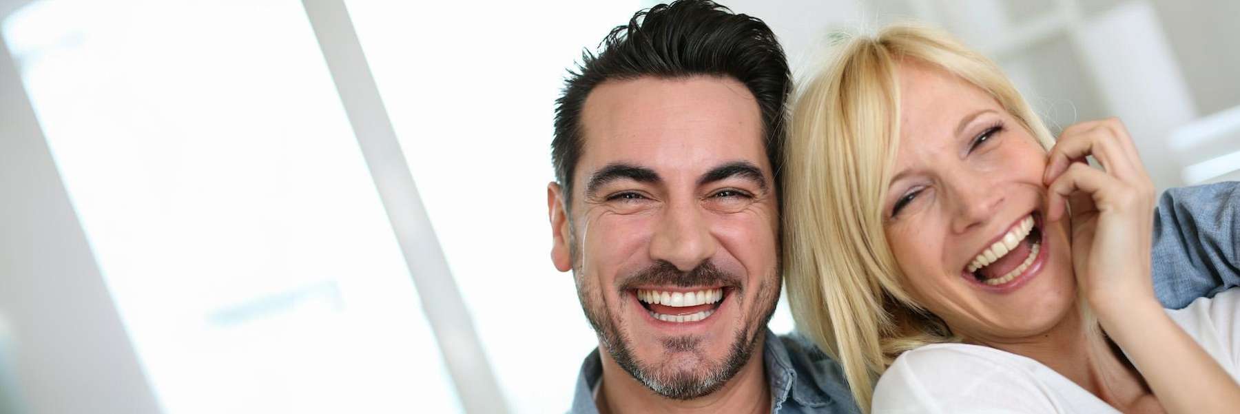 Couple showing off results of professional teeth whitening in Arvada, CO
