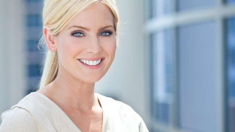 ​Dental Bridge arvada | woman smiling at Arvada dentist