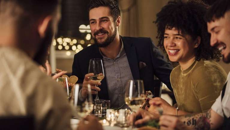 arvada dentist | Friends having dinner during the holidays