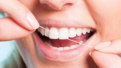 family dentist arvada | woman flossing