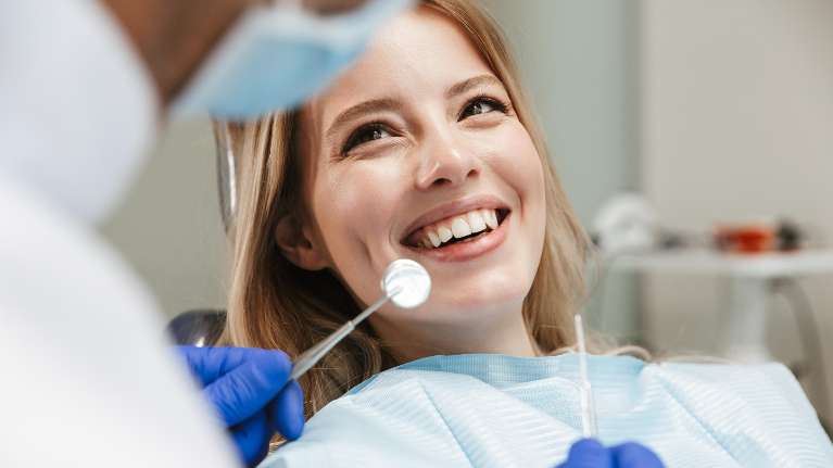 Arvada dentist | woman receiving a dental exam