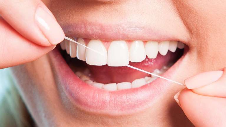 A person flossing | Dentist in Arvada
