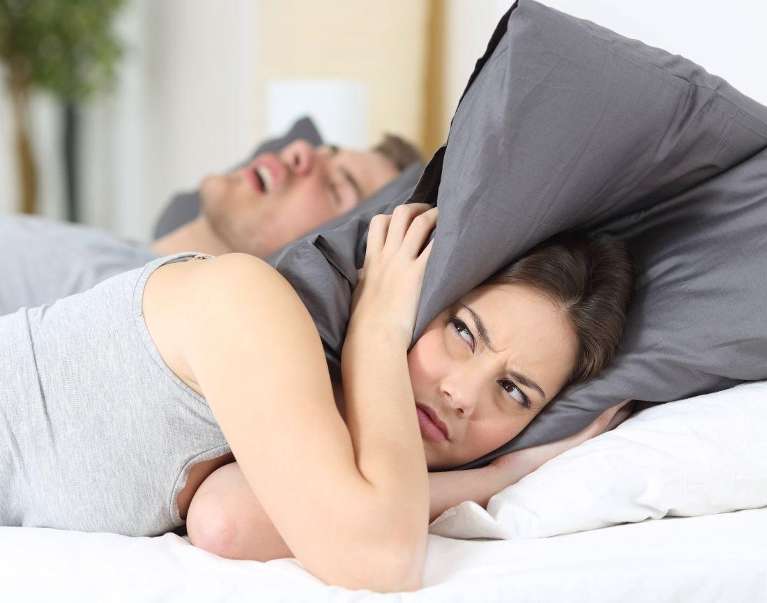 woman can't sleep while cover her ears with pillow