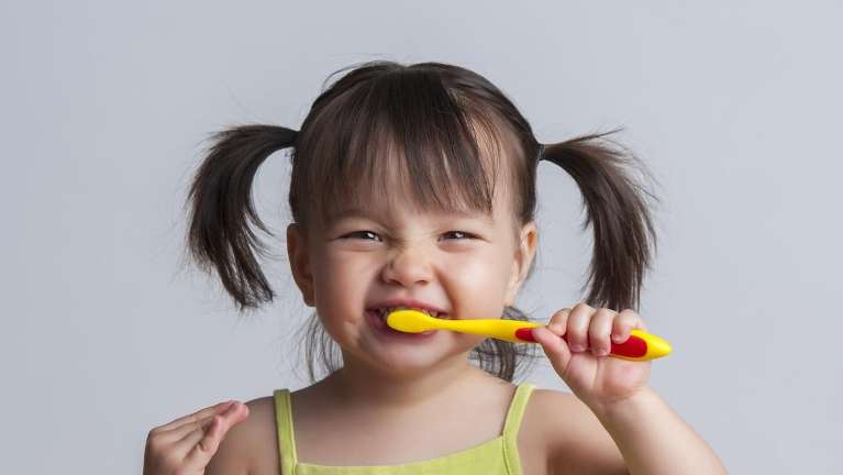 children's dentist Arvada CO | child brushing her teeth