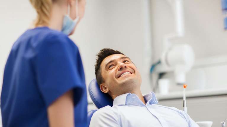 root canals arvada | man at dentist in Arvada