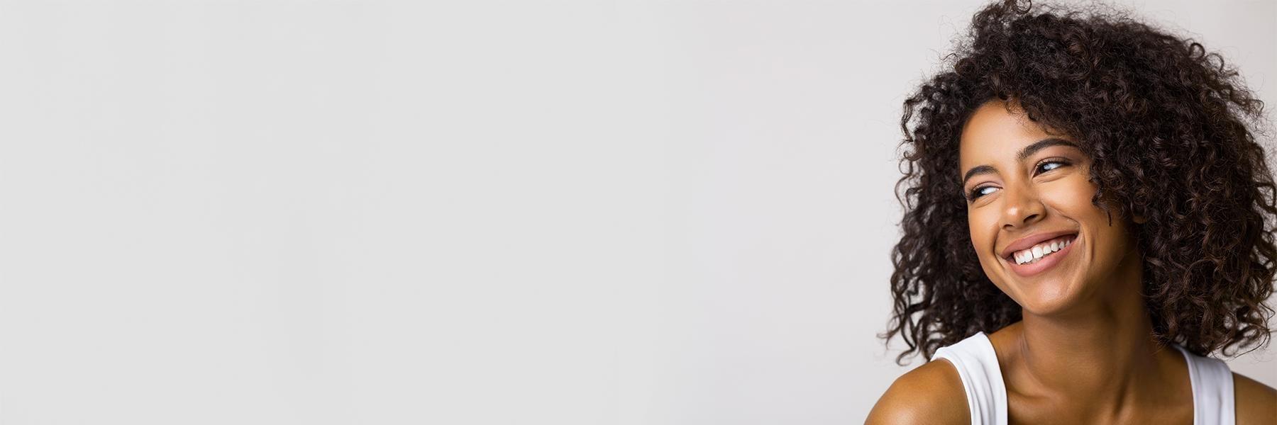 smiling woman after dental crowns in arvada co